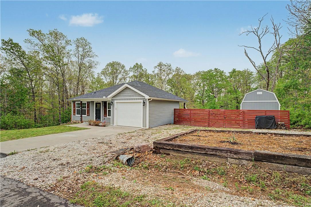 Image 3: The property features a gray exterior with white t