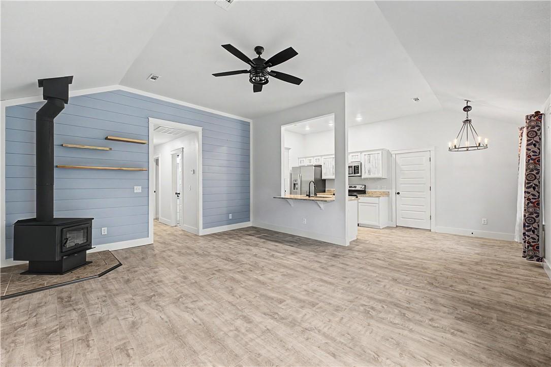 Image 4: The open concept living area features a wood-burni