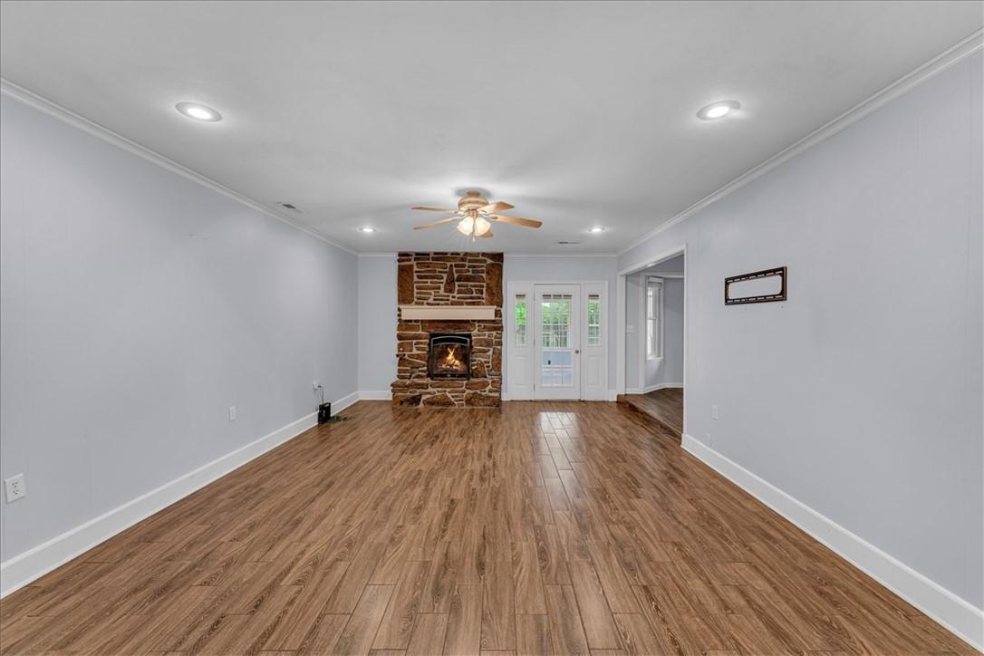 Image 4: Spacious living area featuring wood-finish floorin
