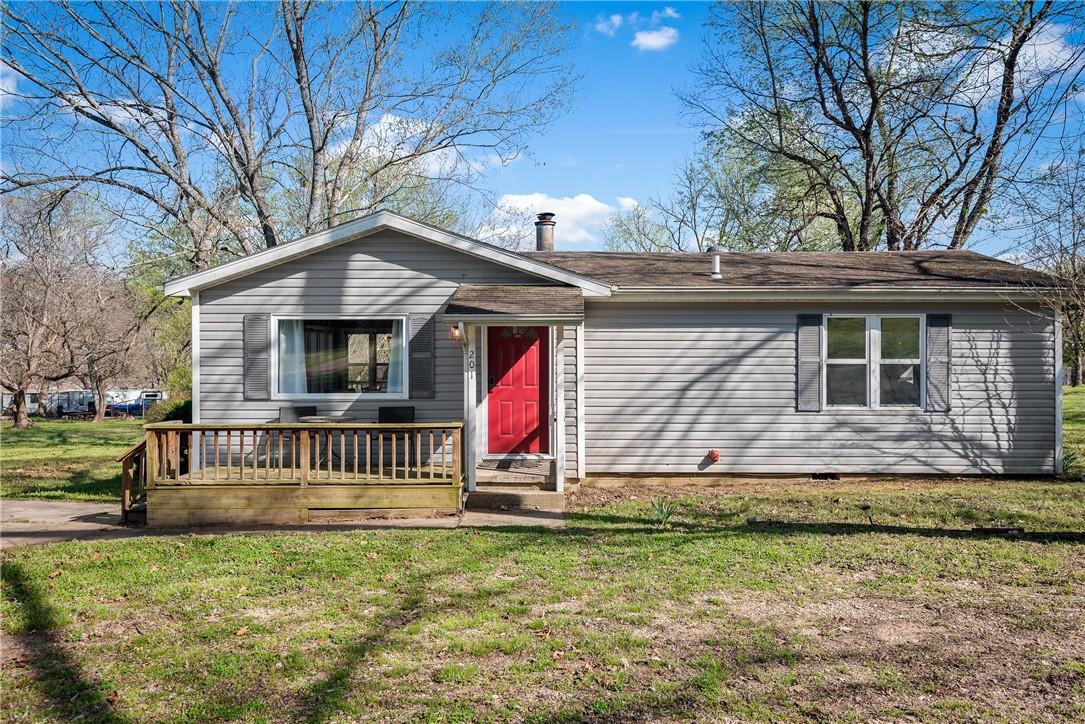 Image 2: Ranch-style exterior with gray horizontal siding a