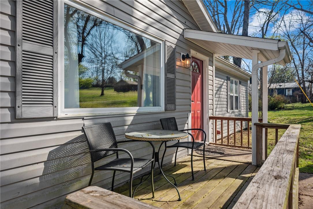 Image 3: Inviting front porch featuring a vibrant red entry