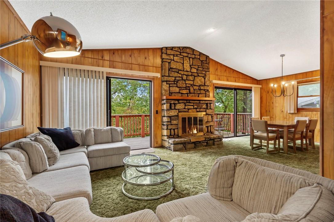 Image 2: Vaulted ceilings, stone fireplace, large windows.