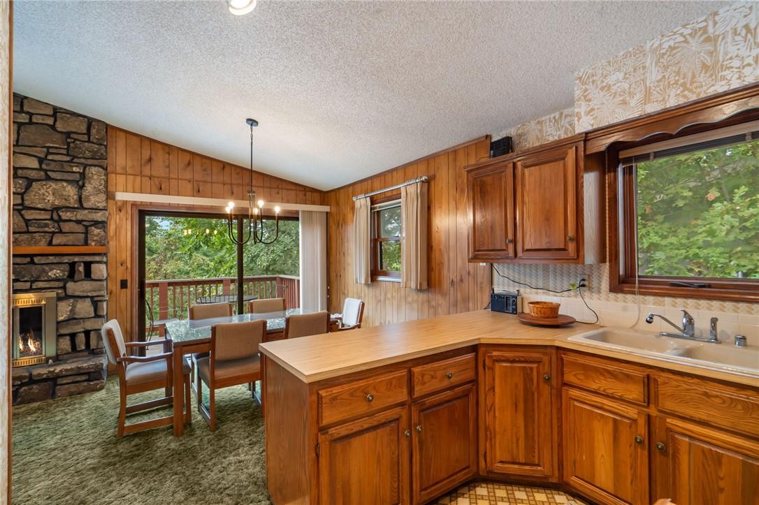 Image 3: Charming cabin-style with rustic wood siding.
