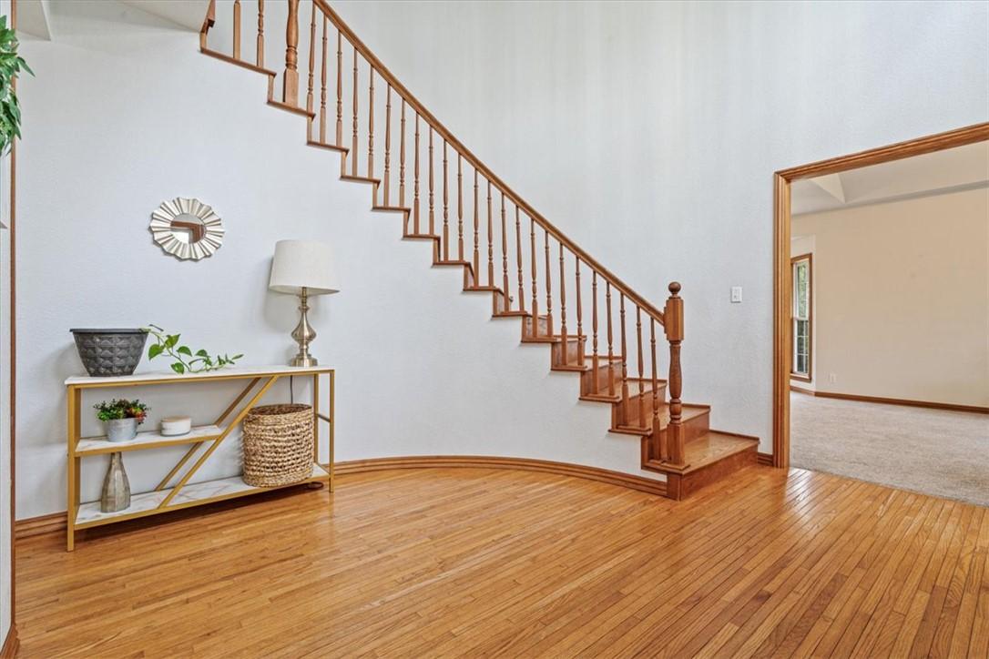 Image 3: Entryway featuring hardwood flooring, a curved sta