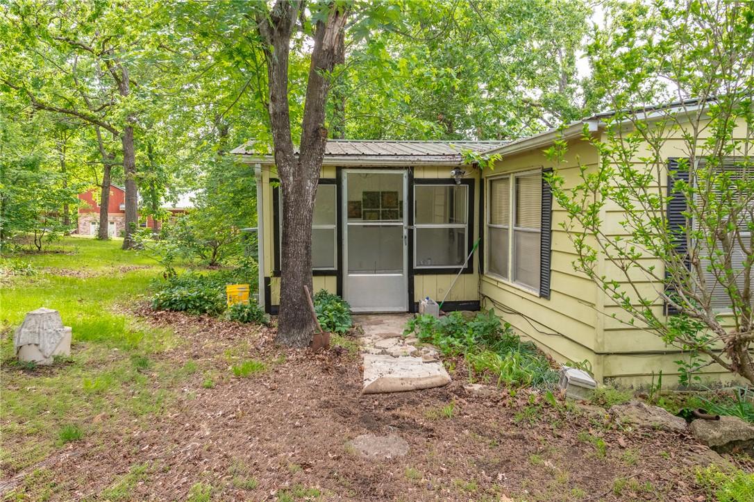 Image 3: Light yellow siding exterior with a screened porch