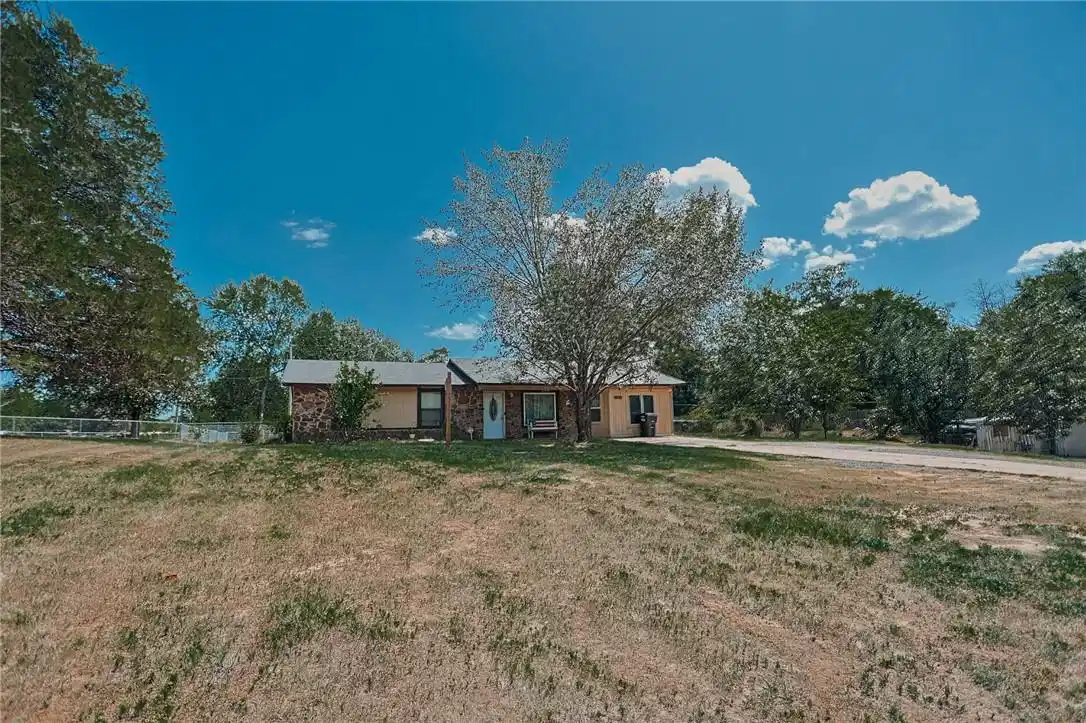 Image 1: Single-story residence featuring a stone and sidin