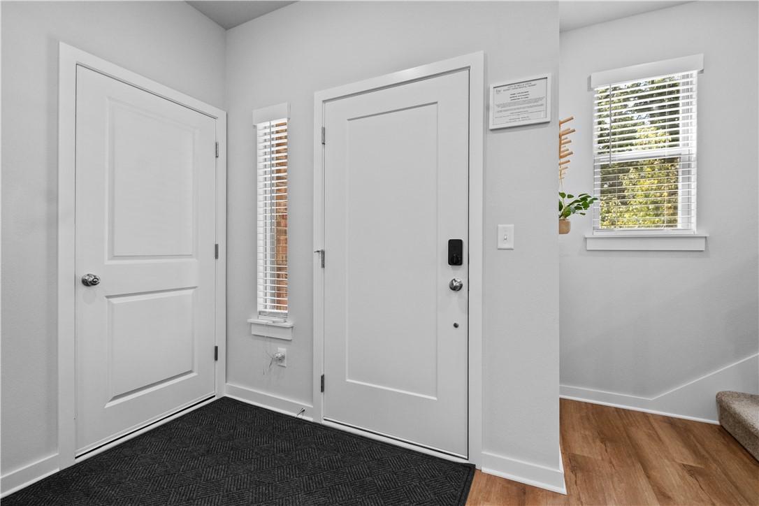 Image 4: Entryway featuring a white door with smart lock, a