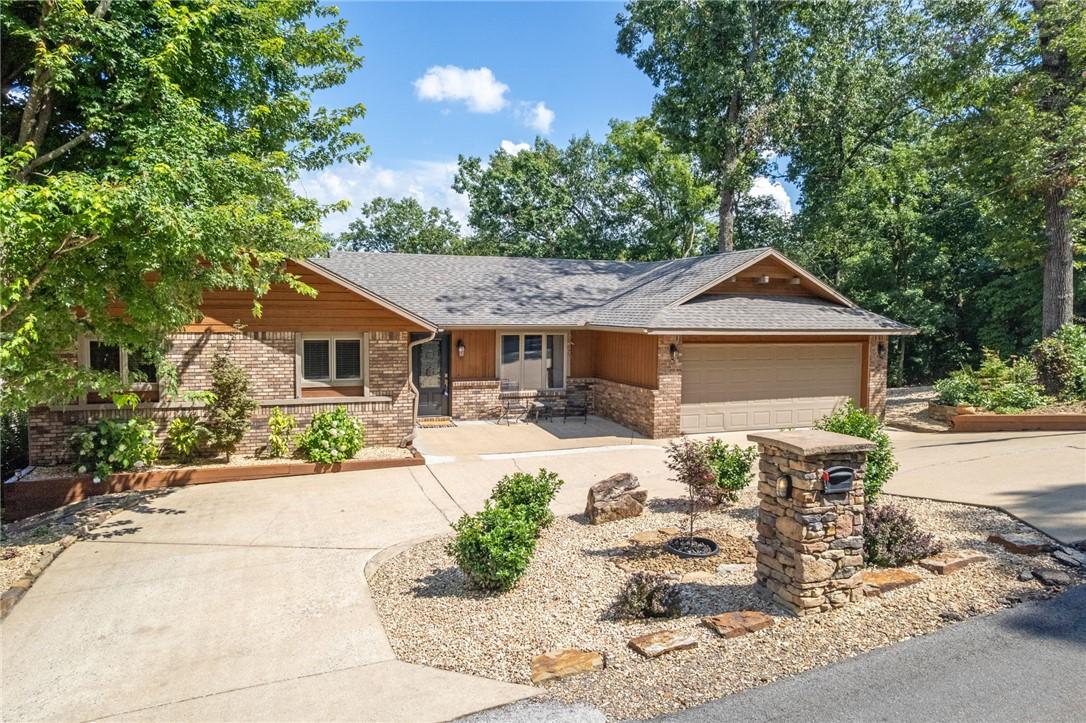 Image 2: Single story home featuring concrete driveway, a g