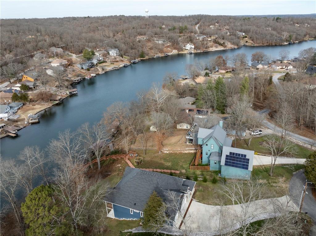 Image 3: Bird&rsquo;s-eye view of the lot, lake, and tree-lined n
