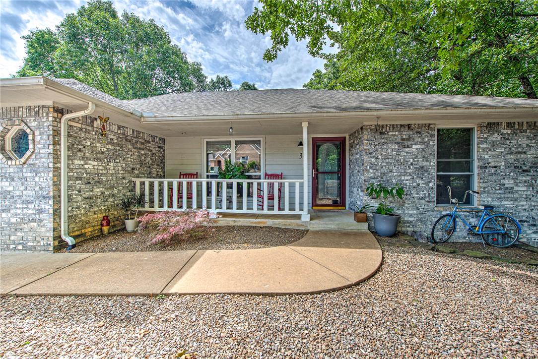 Image 2: Front exterior featuring a covered porch with whit