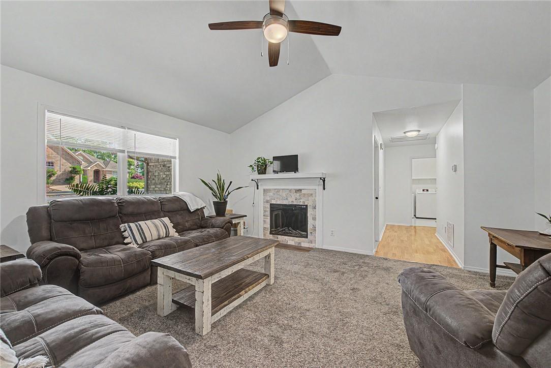 Image 3: Spacious living area featuring a vaulted ceiling a