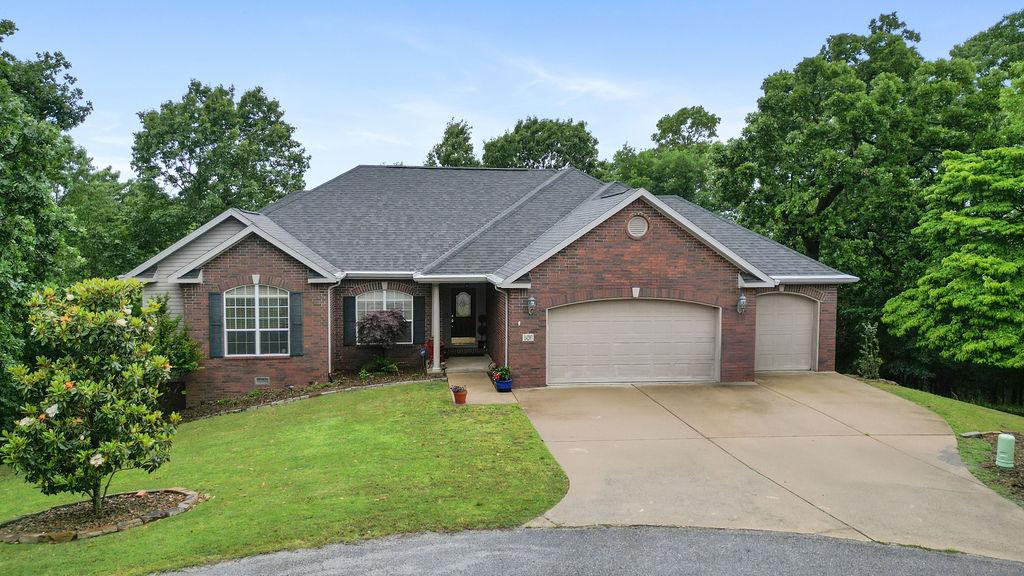 Image 1: Traditional brick exterior with an attached two-ca