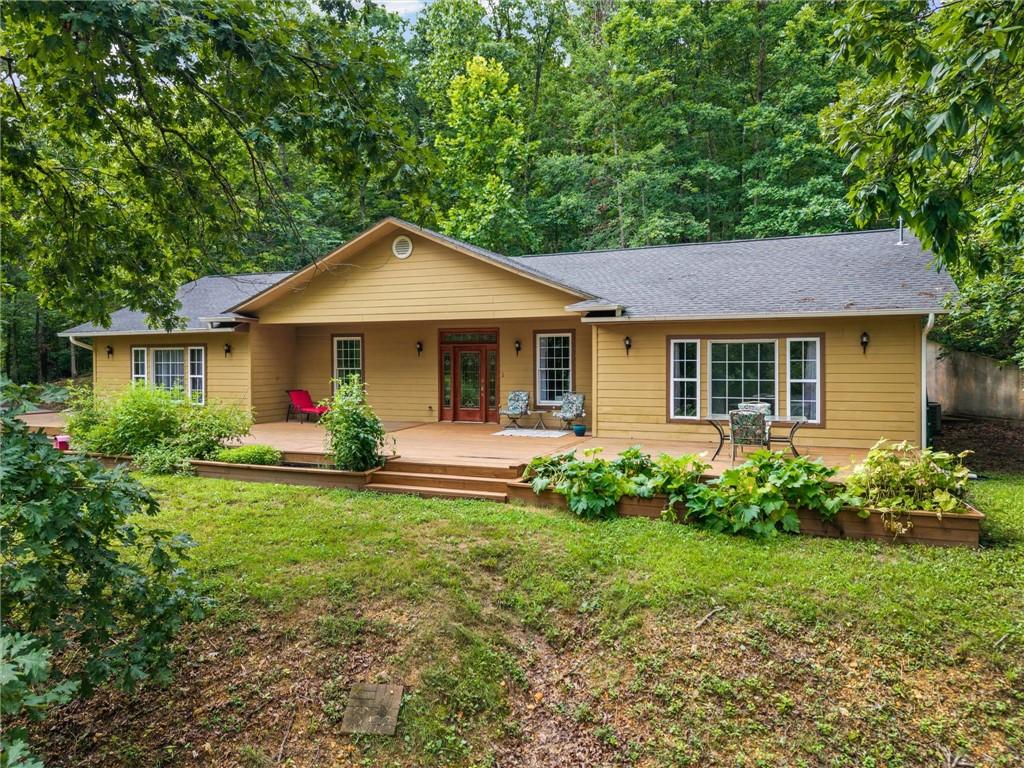 Image 1: Ranch-style exterior with a warm yellow siding, a