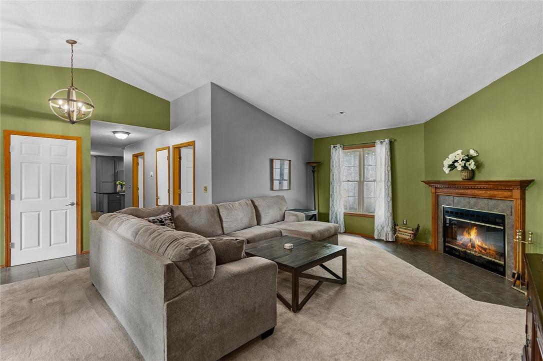 Image 3: Living space featuring a vaulted ceiling and a fir