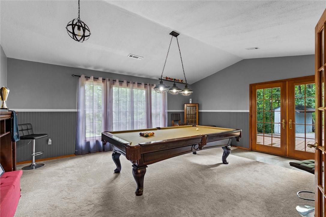 Image 4: Spacious room featuring vaulted ceilings, a large