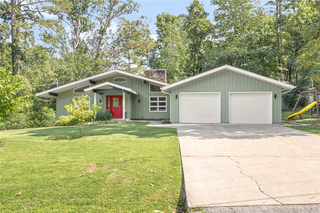 Image 1: Mid-century modern home featuring driveway, a chim