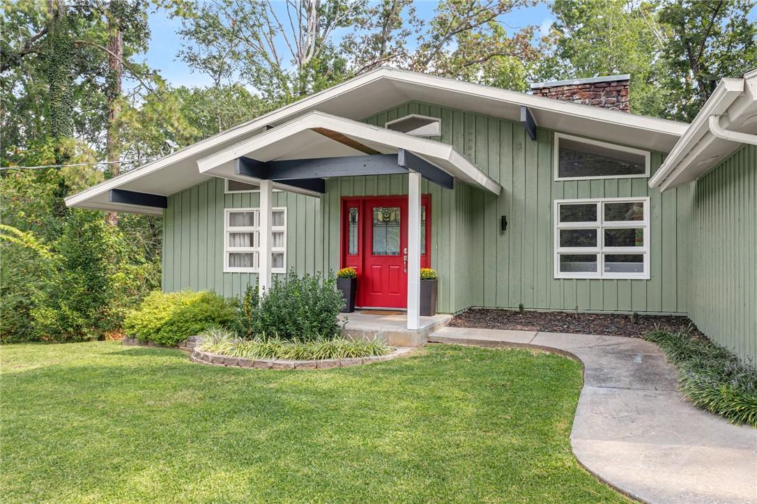 Image 2: Doorway to property featuring a yard and a chimney