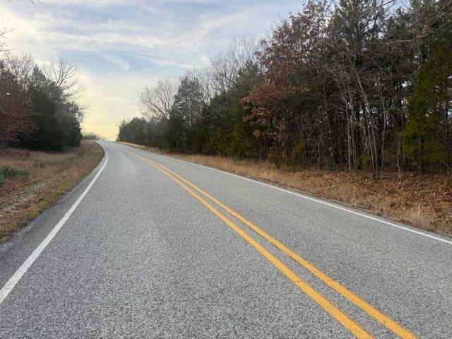 Image 1: The property is bordered by a paved road with doub
