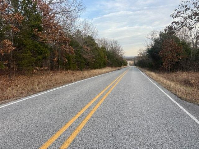 Image 2: The property features a paved road with distinct y