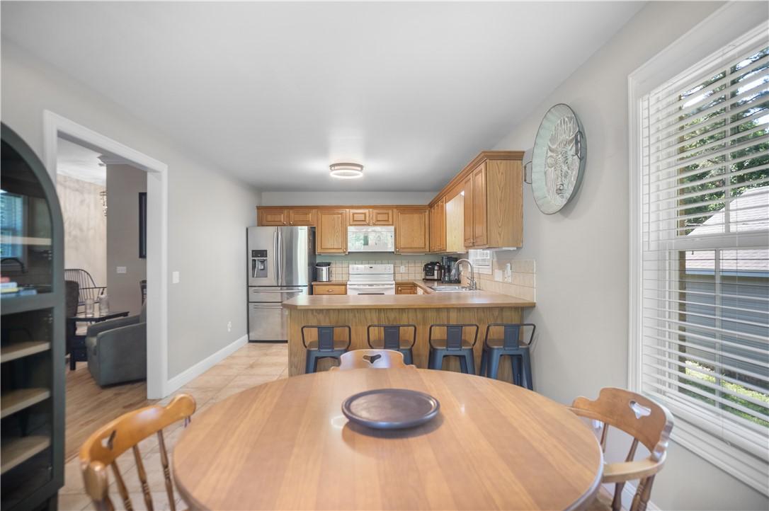 Image 4: Kitchen featuring wood cabinetry, stainless steel