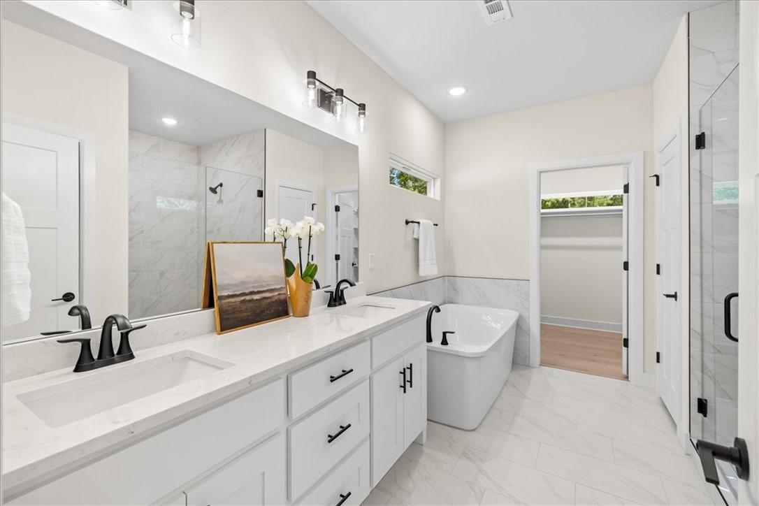 Image 4: Beautiful primary suite retreat featuring dual van
