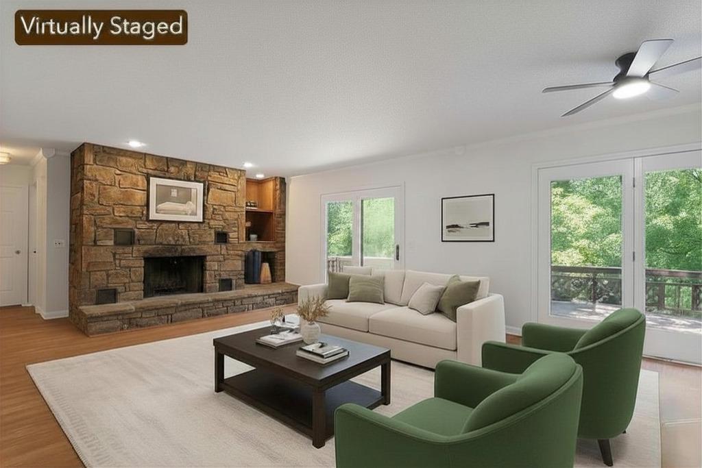 Image 3: Spacious living area featuring a prominent stone f