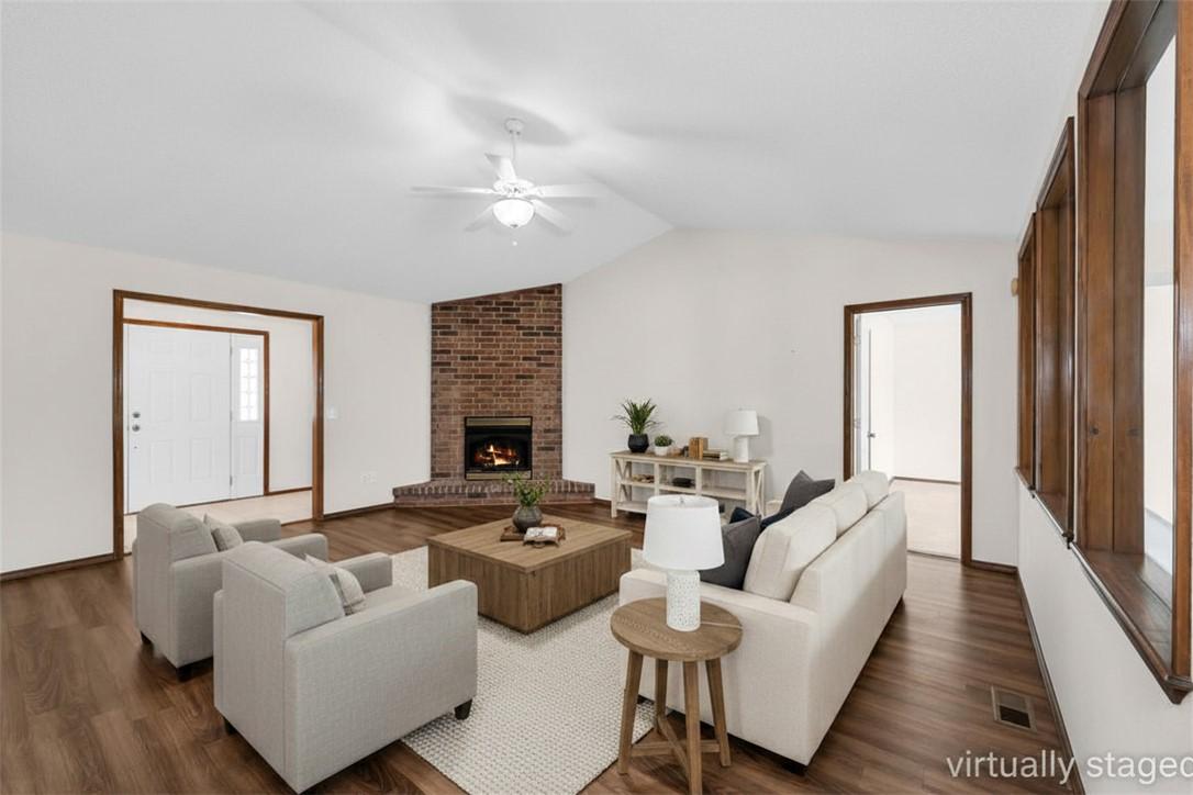 Image 3: Spacious living area featuring a vaulted ceiling a