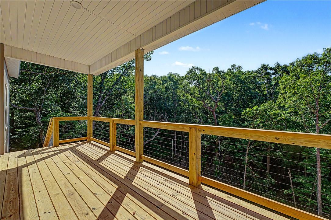 Image 4: Expansive covered deck featuring natural wood floo