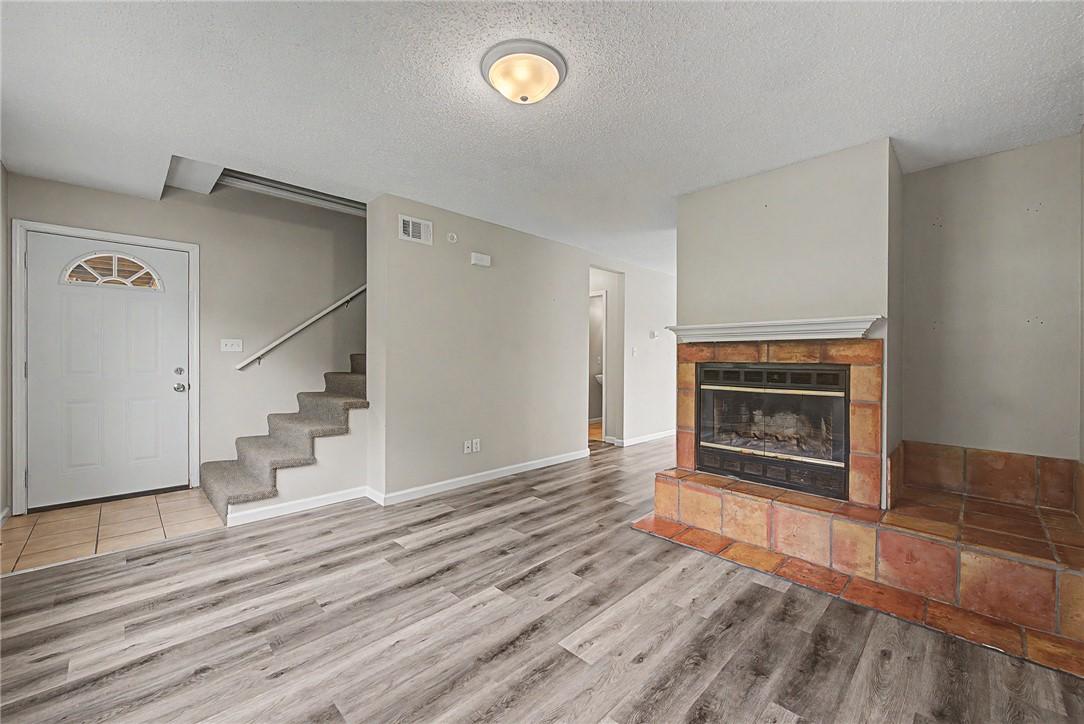 Image 3: Each of the end units include a fireplace in the l