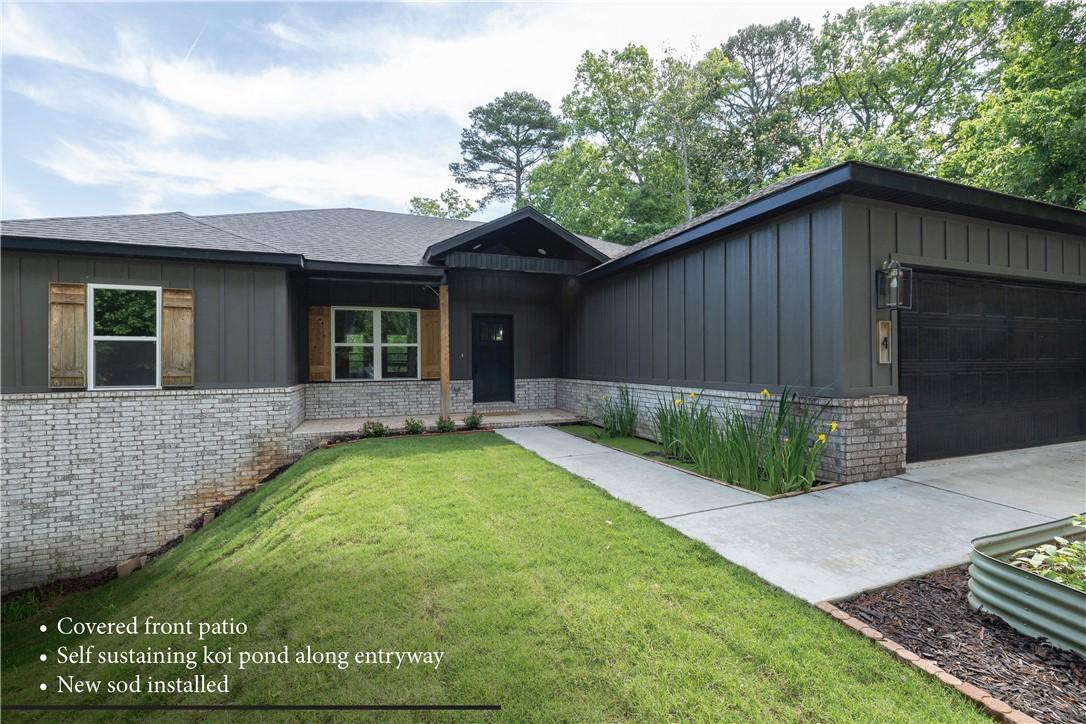 Image 4: Modern exterior featuring dark vertical siding, a