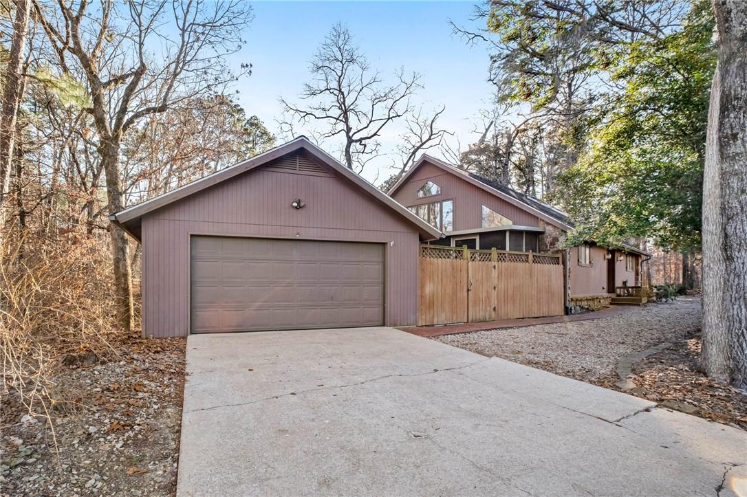 Image 4: View of front of home with concrete driveway and a