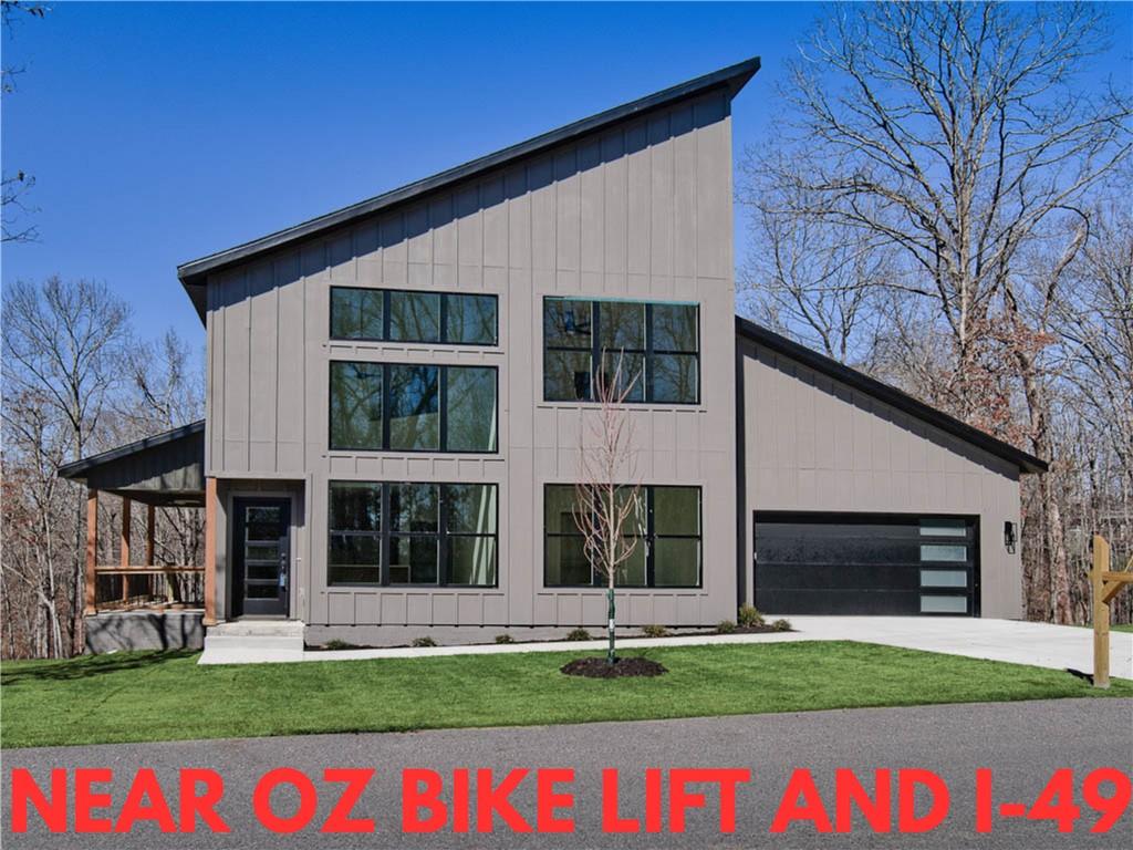 Image 1: View of front of house featuring board and batten