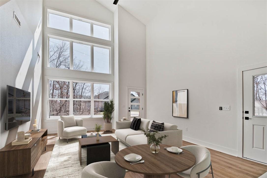Image 4: Living room featuring wood finished floors and vau