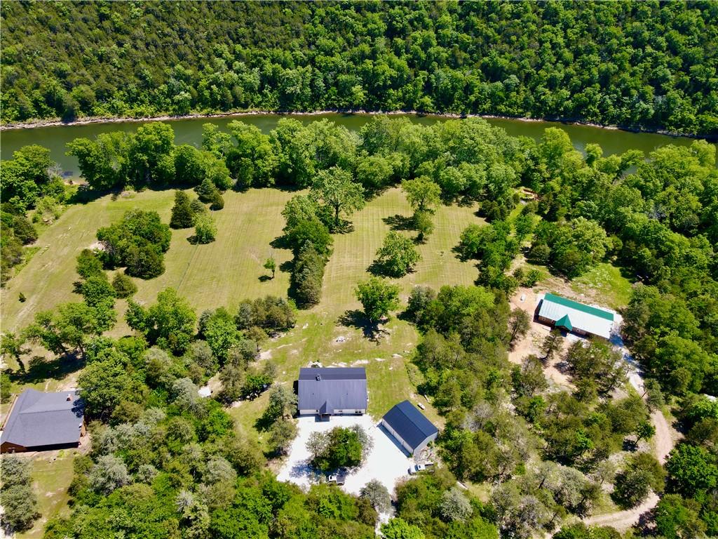 Image 1: Extensive property featuring a riverfront, mature