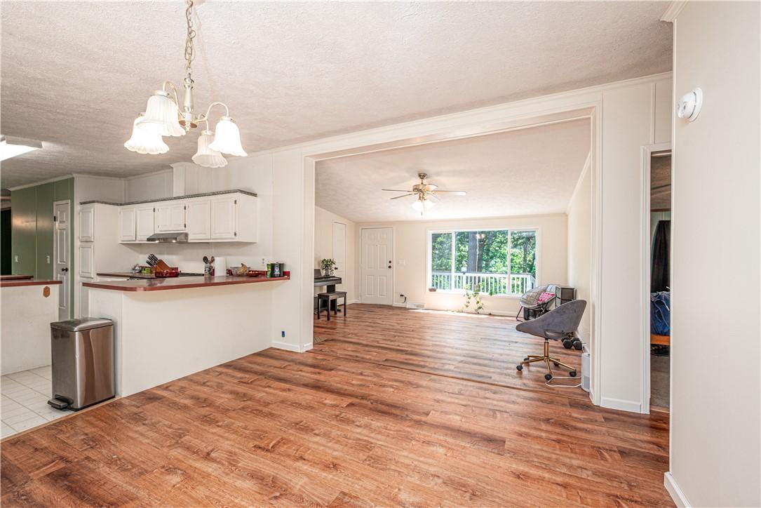 Image 2: Open-concept living area with wood-finish flooring