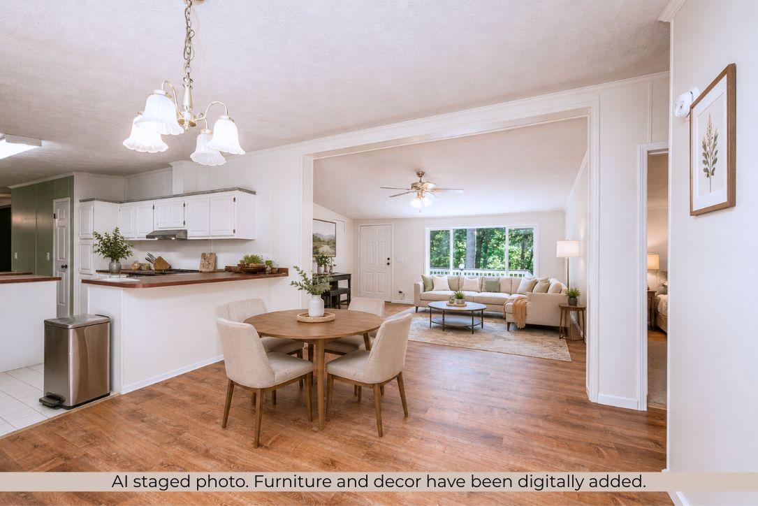 Image 3: Dining area featuring wood-finish flooring and a b
