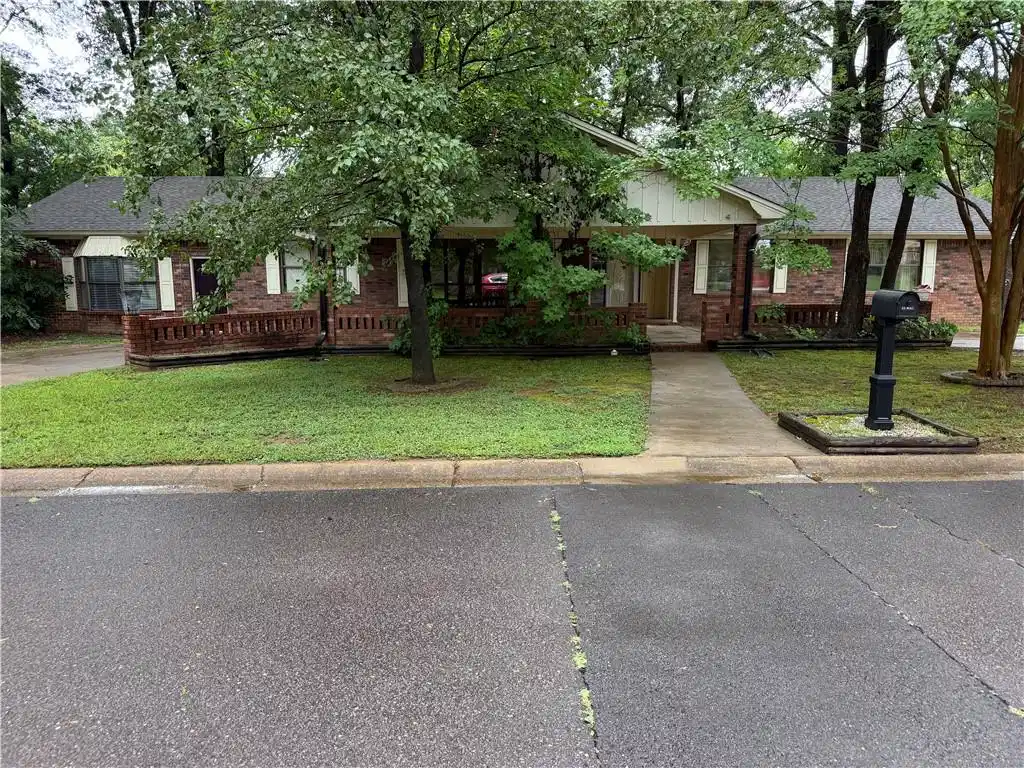 Image 1: Traditional brick residence featuring a front porc