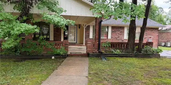 Image 2: Traditional brick facade home with a covered front