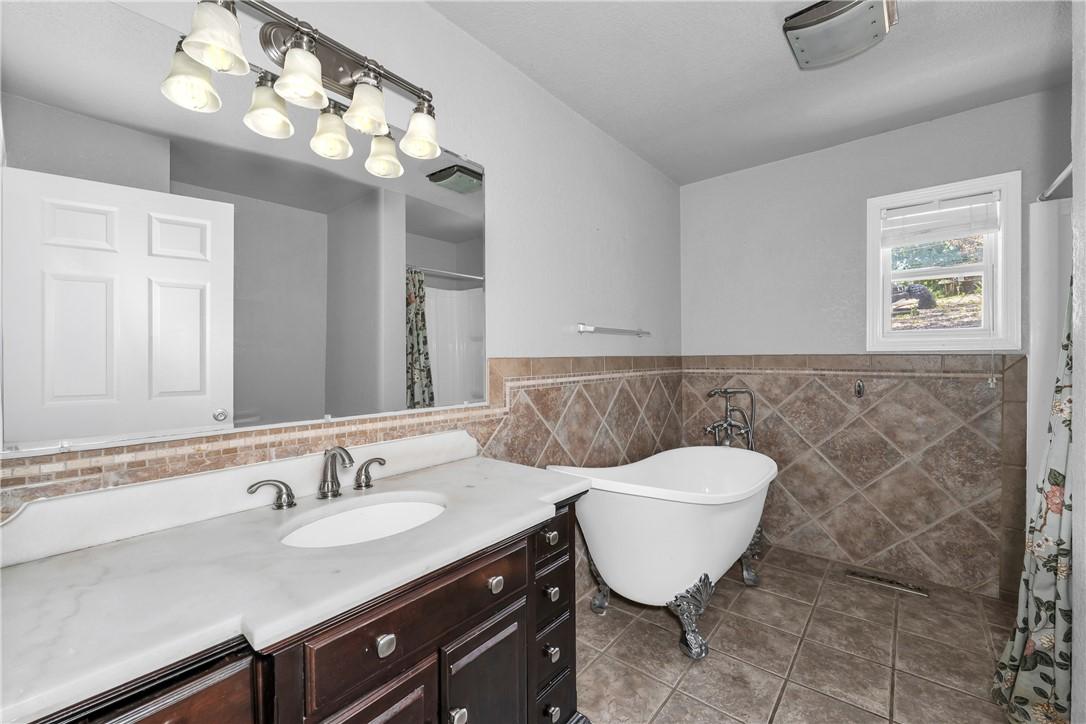 Image 4: Bathroom featuring a freestanding clawfoot bathtub