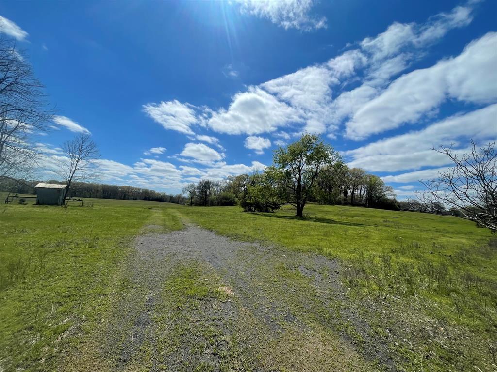 Image 3: Expansive green field featuring a gravel path and