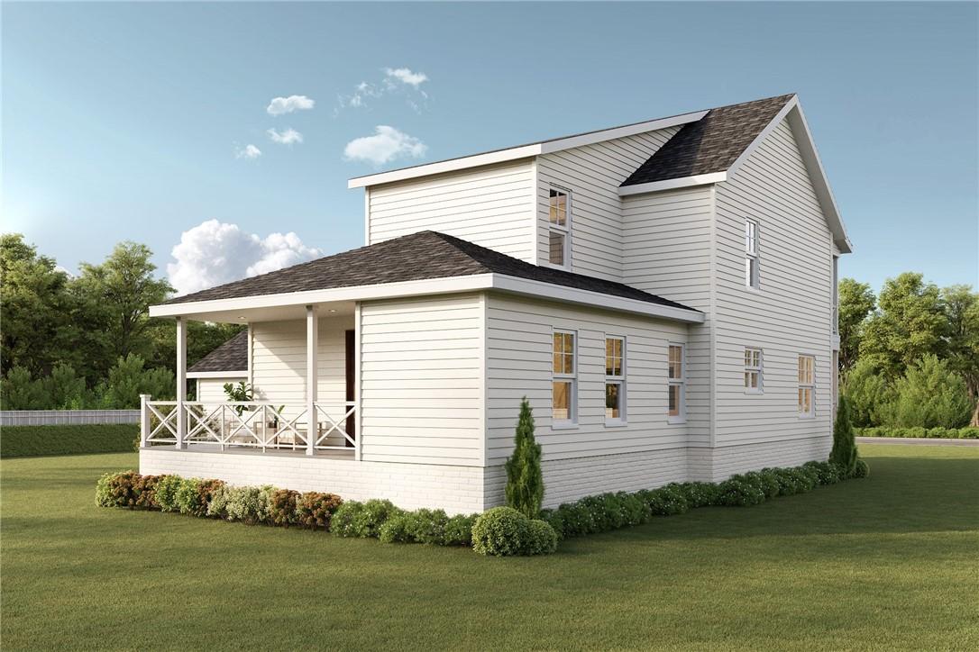 Image 2: View of side of property with a lawn and a shingle