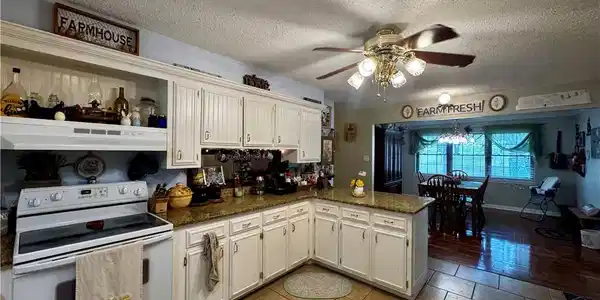 Image 4: Kitchen with electric stove, a textured ceiling, c