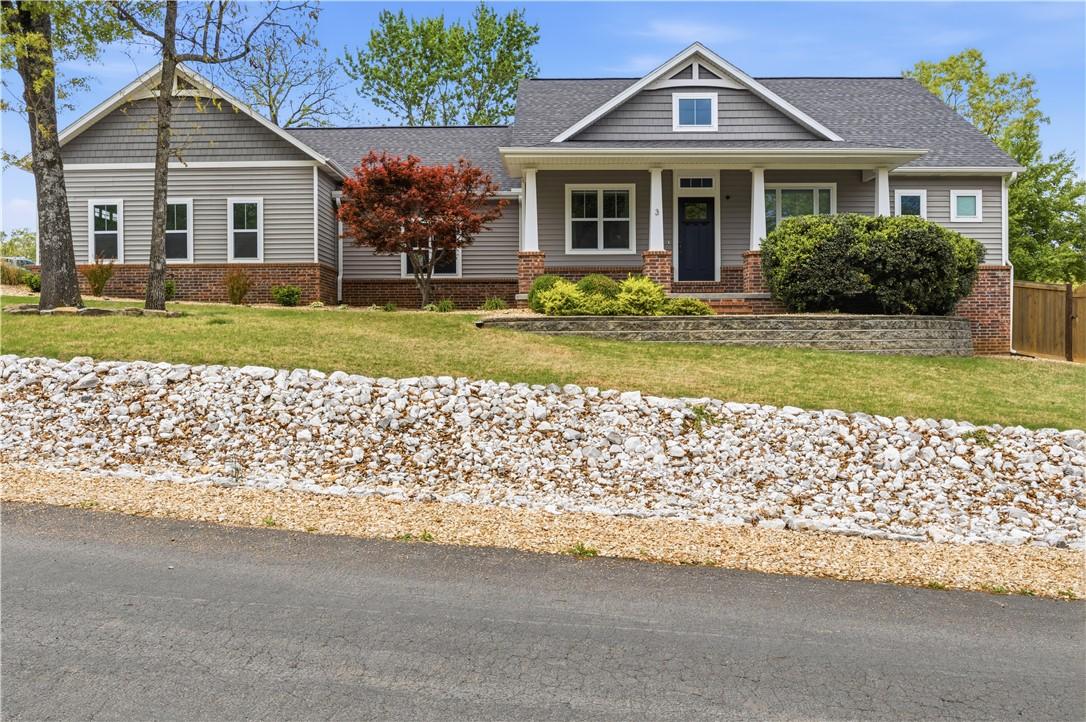 Image 1: The property features a tasteful grey siding and b