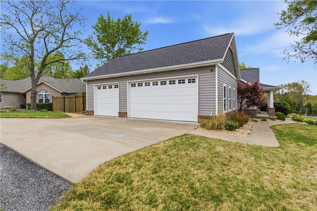 Image 2: The property features a two-car garage with white