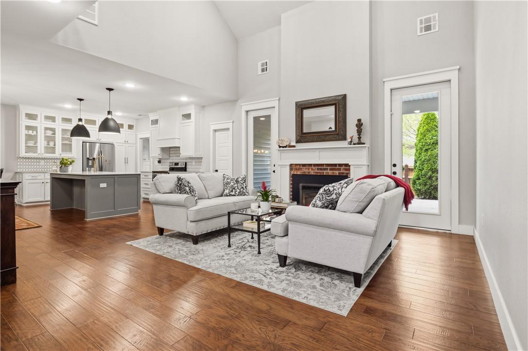 Image 3: Living space featuring hardwood flooring, a firepl