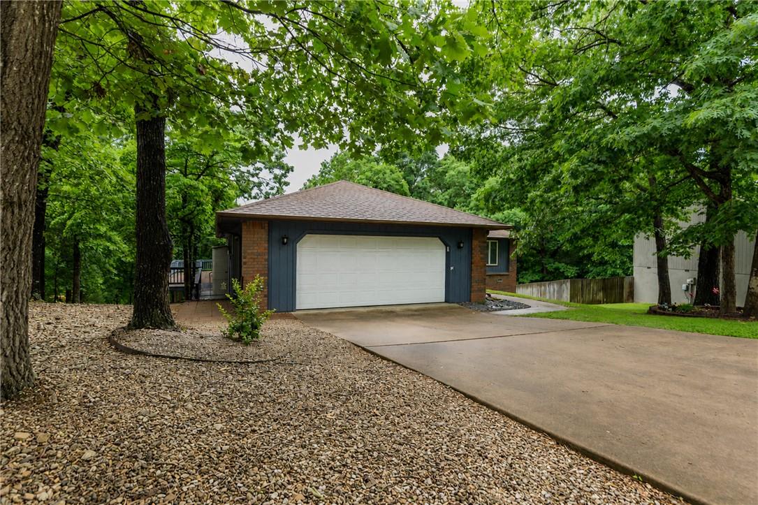 Image 3: Exterior featuring a two-car garage with a white d