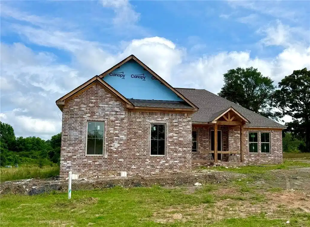 Image 1: New construction home featuring a variegated brick