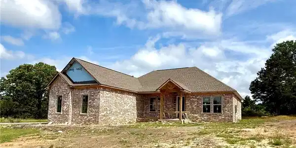 Image 2: Brick exterior residence featuring a covered front