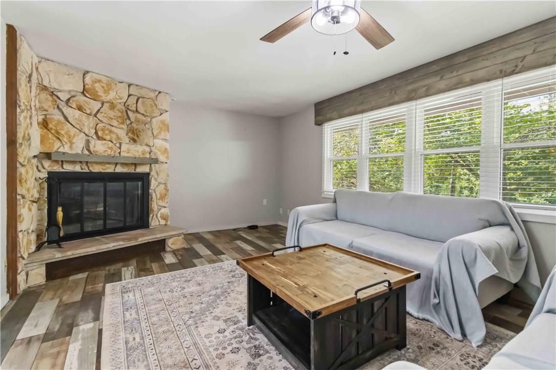 Image 4: Stone-clad fireplace with a hearth, wood-finish fl