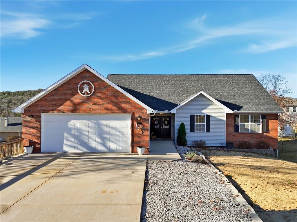 Image 1: View of front of house featuring brick siding, con